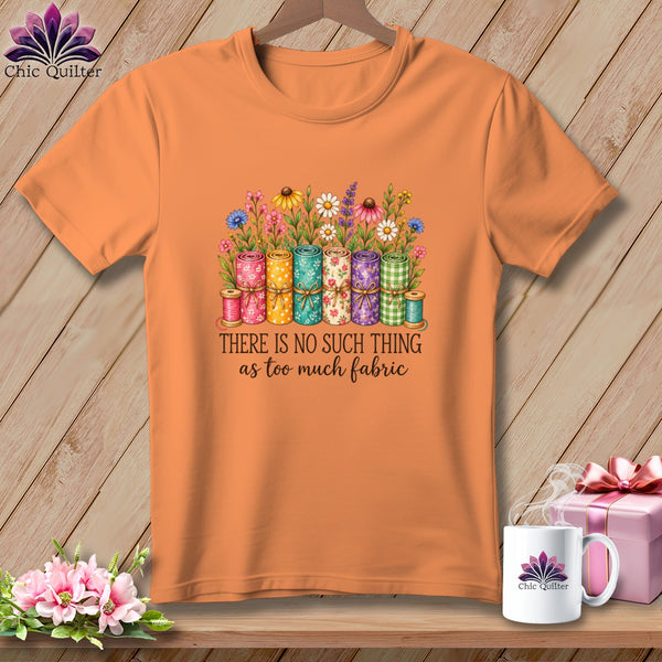 Orange t-shirt featuring rolled fabric graphic, floral illustration, and text reading There is no such thing as too much fabric.