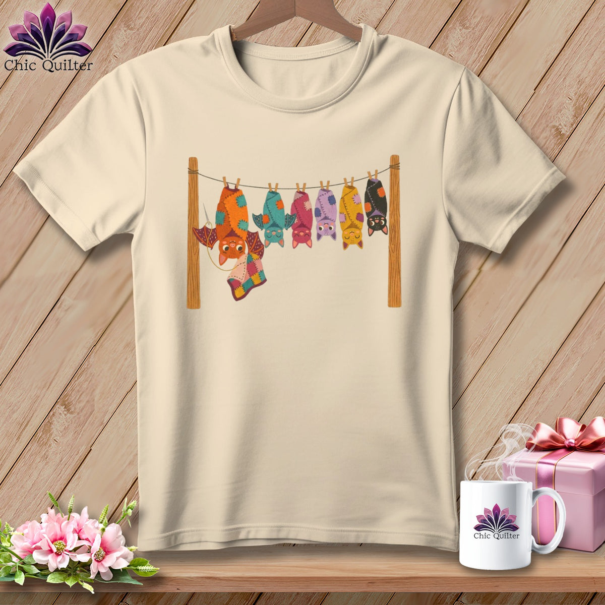 Cream t-shirt with colorful cartoon bats hanging on a clothesline.