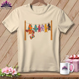 Cream t-shirt with colorful cartoon bats hanging on a clothesline.