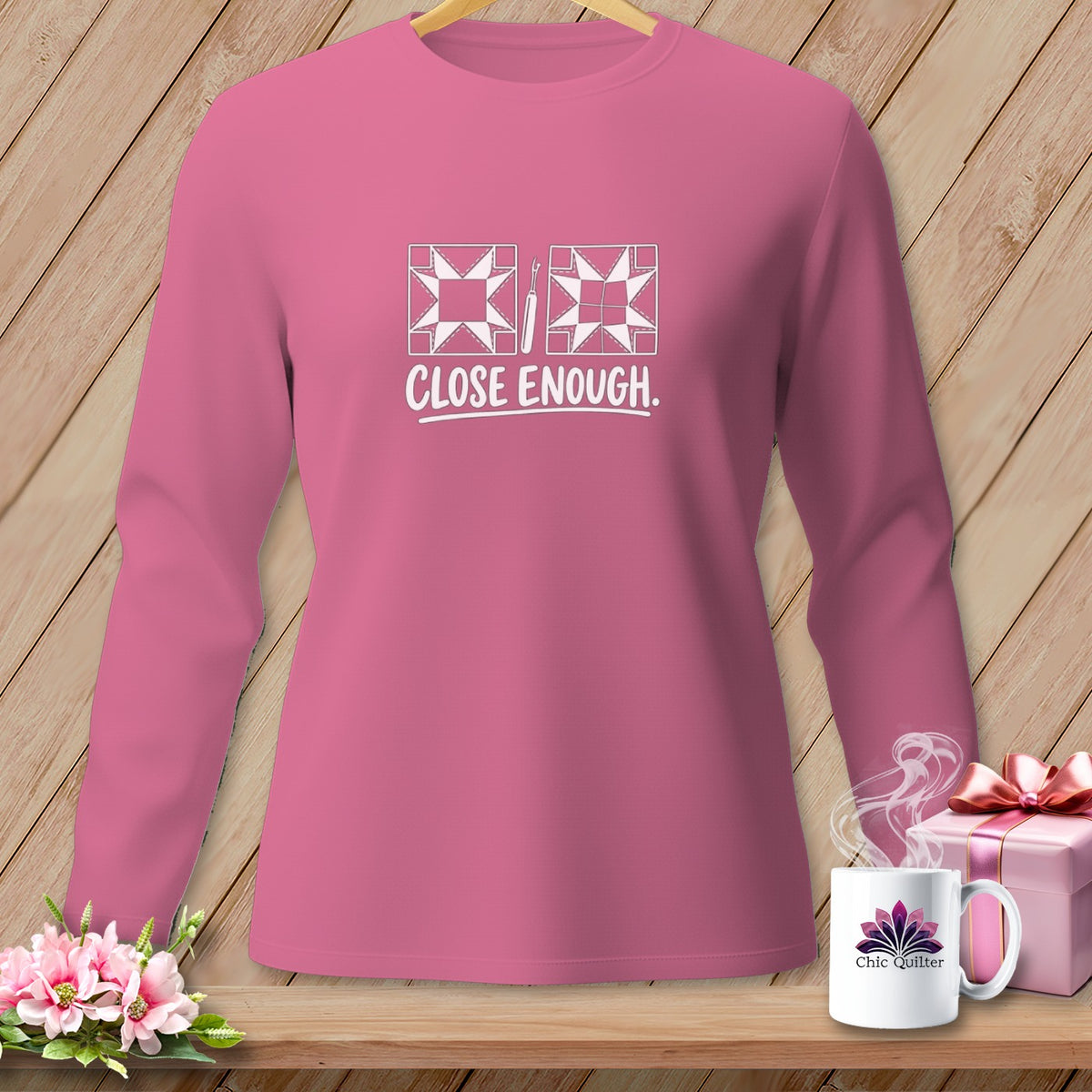 Pink long-sleeve shirt with "CLOSE ENOUGH." and quilt block graphic.