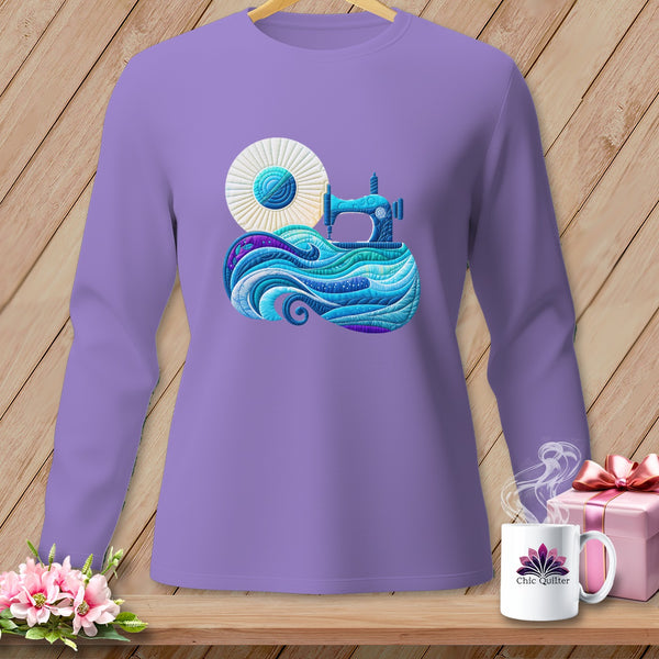 Lavender long-sleeve shirt with a graphic of a sewing machine and quilted waves.
