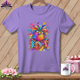 A purple t-shirt featuring a colorful, whimsical owl graphic sitting in a woven basket.