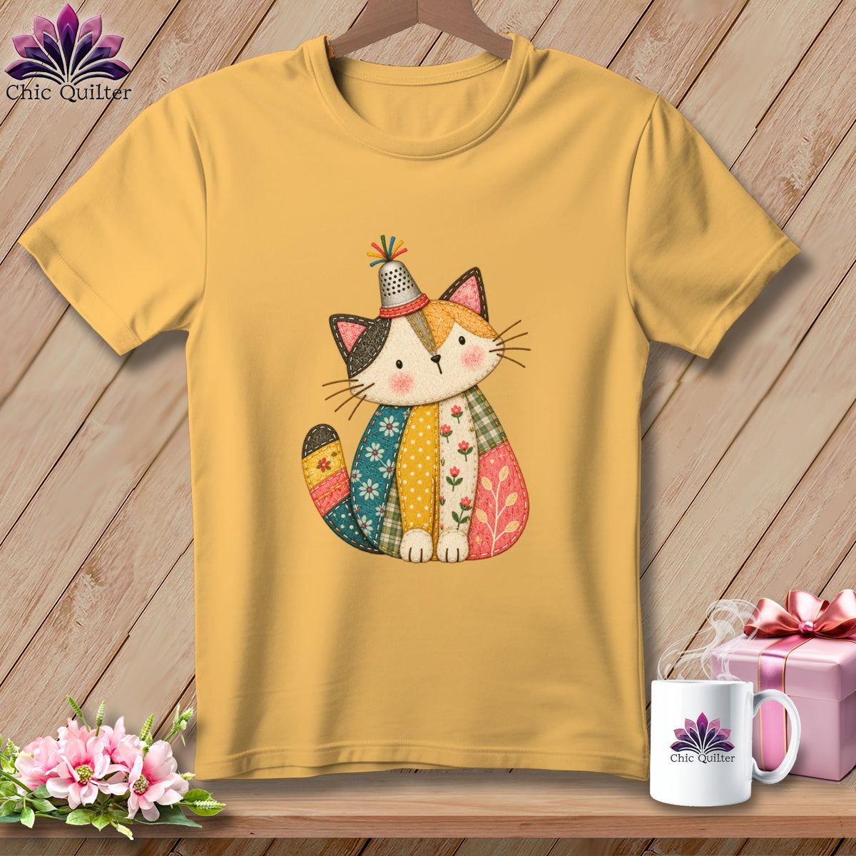 Mustard yellow t-shirt featuring a cute, quilted patchwork cat illustration with a thimble hat.