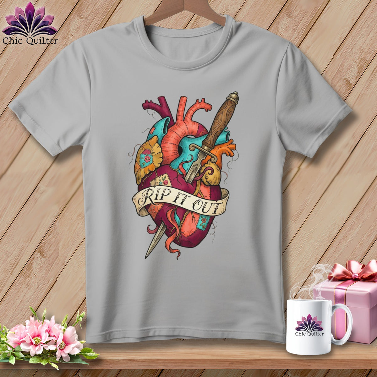 Grey t-shirt with a stylized heart graphic pierced by a dagger and a banner reading "RIP IT OUT".