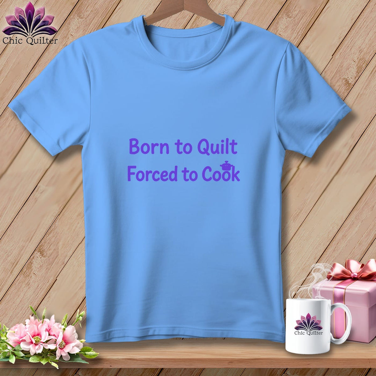 Blue t-shirt with purple text "Born to Quilt Forced to Cook".