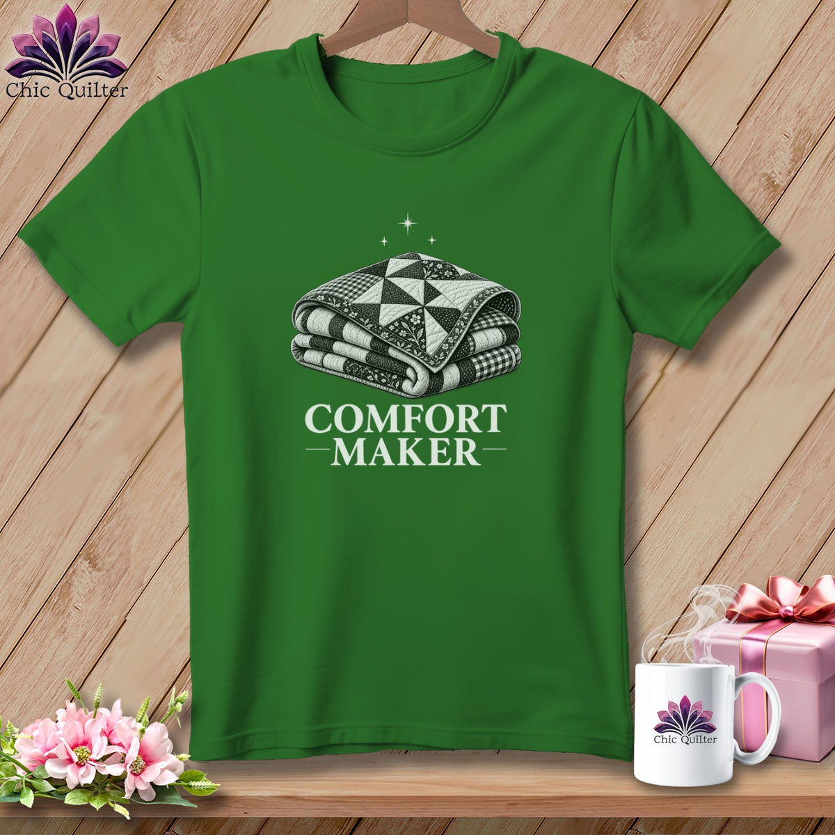 Green t-shirt with a folded quilt and "COMFORT MAKER" text.