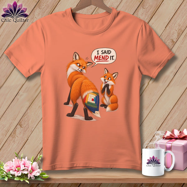 T-shirt with two foxes, one with a patchwork tail, saying "I SAID MEND IT."