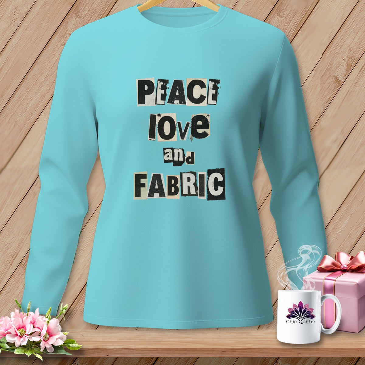Teal long-sleeve shirt with "Peace Love and Fabric" text in collage style.