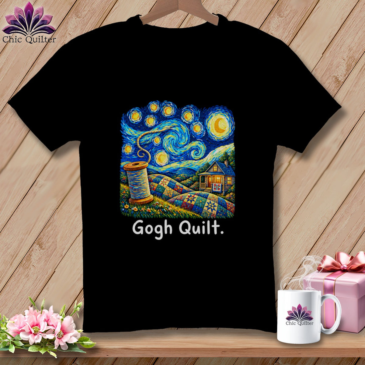 Black t-shirt with a swirling starry sky, quilt landscape, and spool of thread.