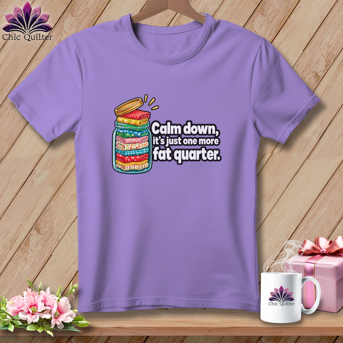 A purple crewneck t-shirt featuring a jar filled with folded fabric and text reading Calm down, it's just one more fat quarter.