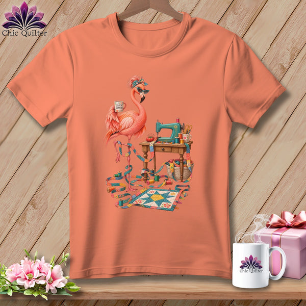 Peach t-shirt with flamingo, sewing machine, fabric, and quilt design.