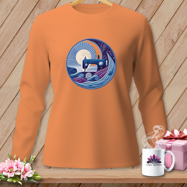 Orange long-sleeve shirt with a circular design of a sewing machine, sun, and waves.