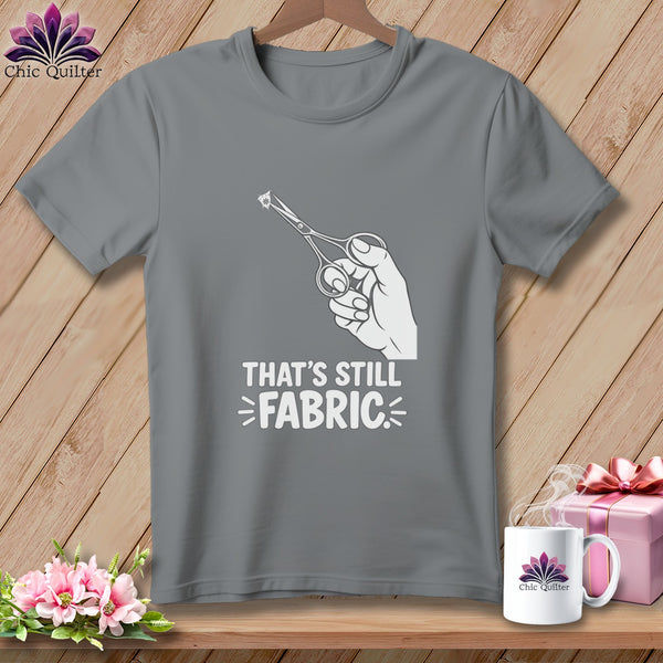 Gray t-shirt with scissors cutting fabric and text "THAT'S STILL FABRIC".