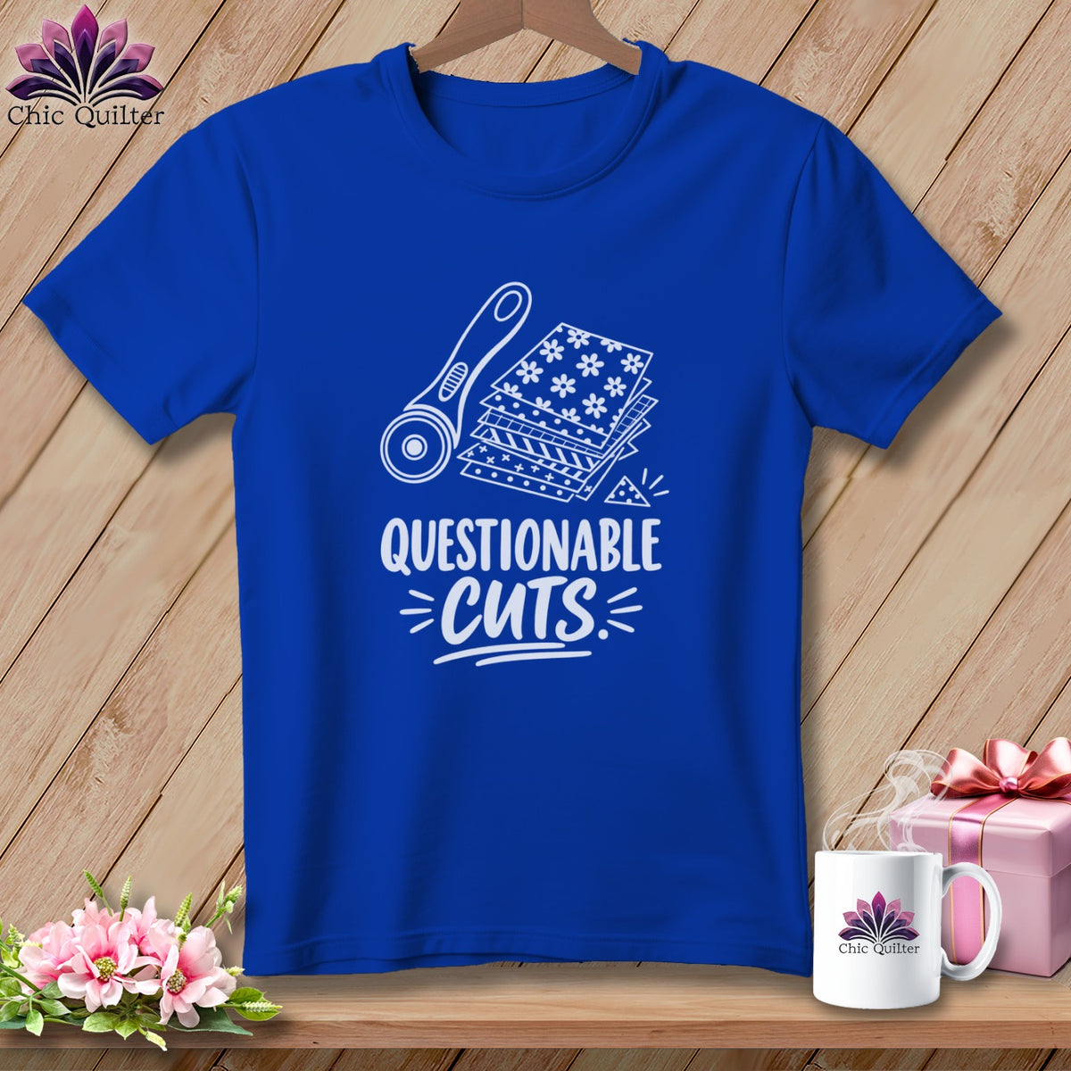 Royal blue t-shirt with "Questionable Cuts" graphic and quilting tools.