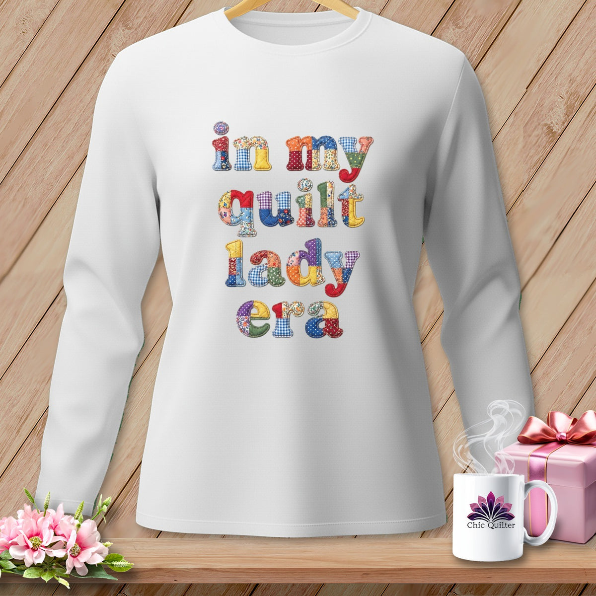 White sweatshirt with "in my quilt lady era" text in colorful patchwork font.