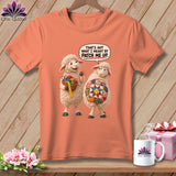 Two sheep on an orange t-shirt; one holds sewing supplies, the other a quilt.