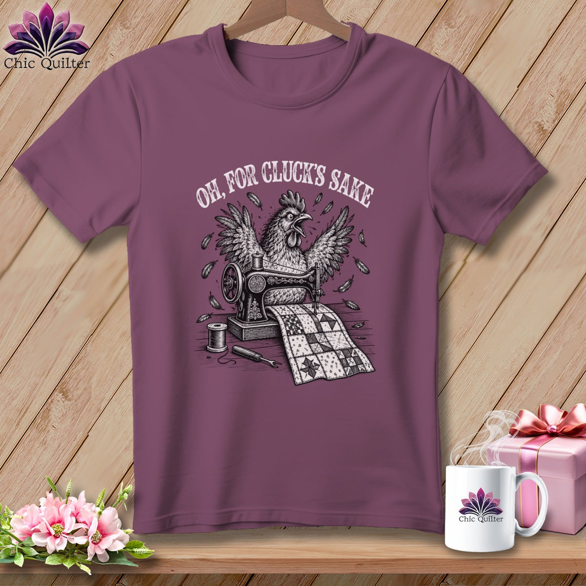 T-shirt with a chicken sewing a quilt, text reads "Oh, For Cluck's Sake".