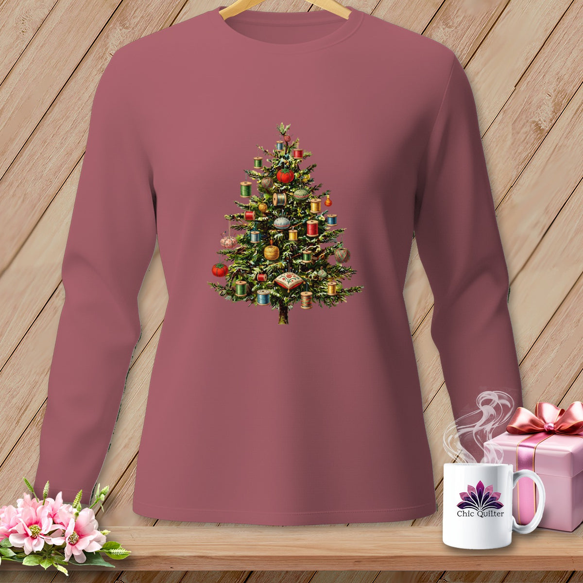 Long-sleeved shirt with a Christmas tree adorned with spools of thread and sewing notions.