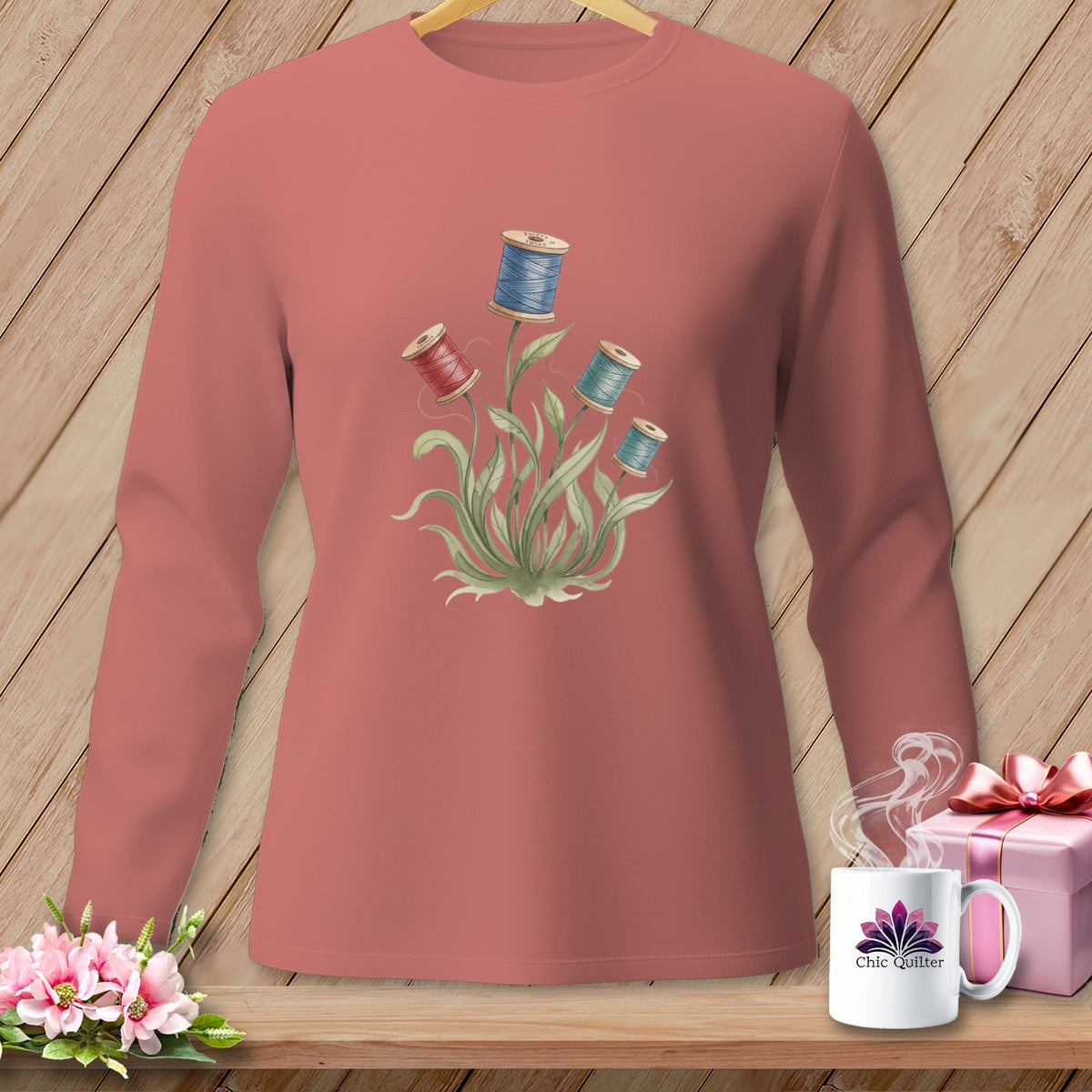 Pink long-sleeve shirt with floral spool of thread graphic and "Chic Quilter" mug.