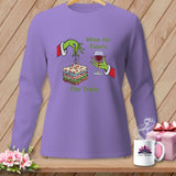 Purple long-sleeve shirt with Grinch hands, fabric stack, wine, and text.