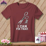 Maroon t-shirt with scissors, thread, and text 