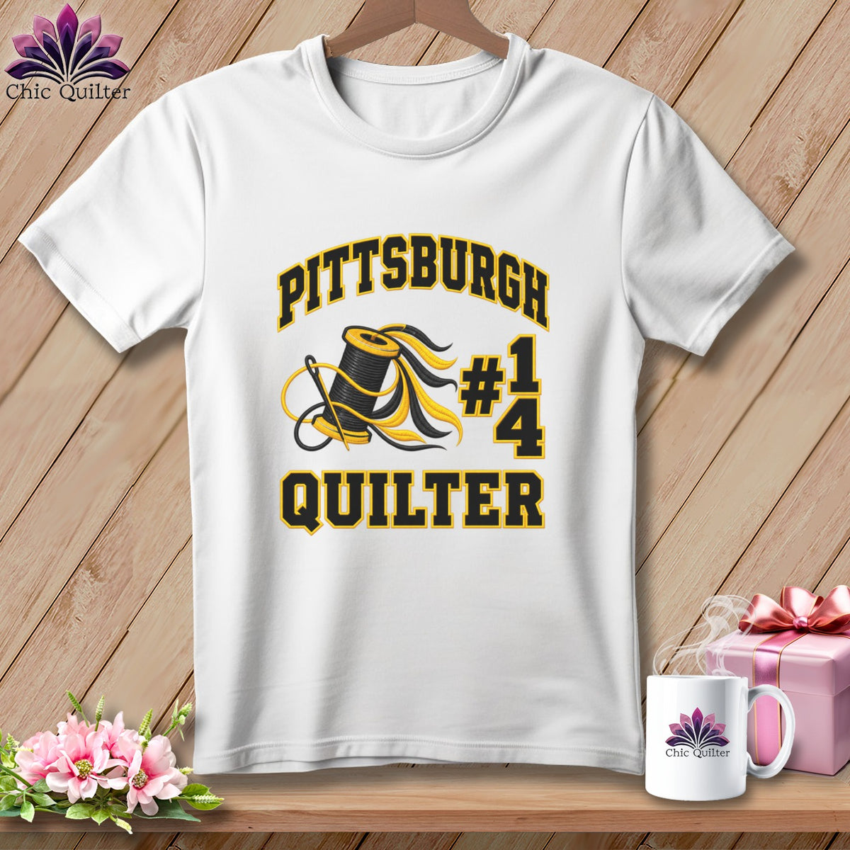 White crewneck t-shirt with black and yellow Pittsburgh Quilter text, a spool, needle, and a 1/4 icon.