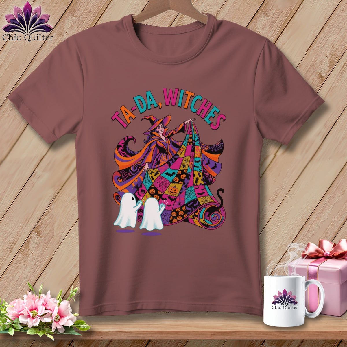 T-shirt with colorful Halloween graphic of a witch, ghosts, and pumpkins, reads "TA-DA, WITCHES".