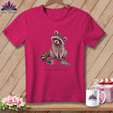 Pink t-shirt with raccoon, thread, and floral fabric design and text.