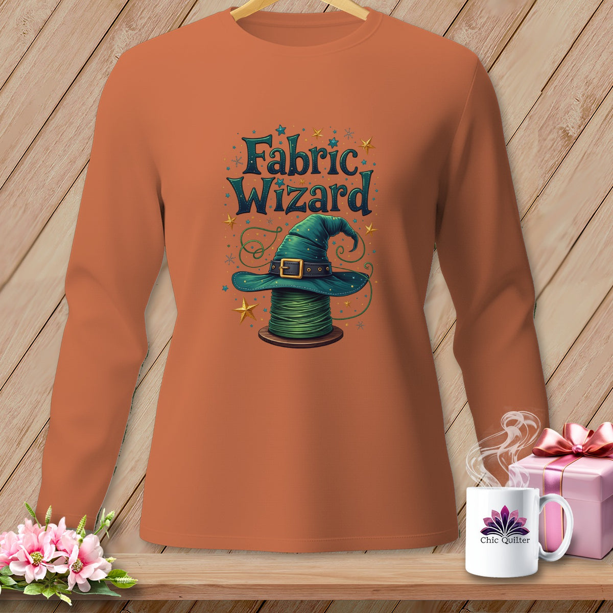 Orange long-sleeve shirt with "Fabric Wizard" text and a witch hat on a spool of thread.
