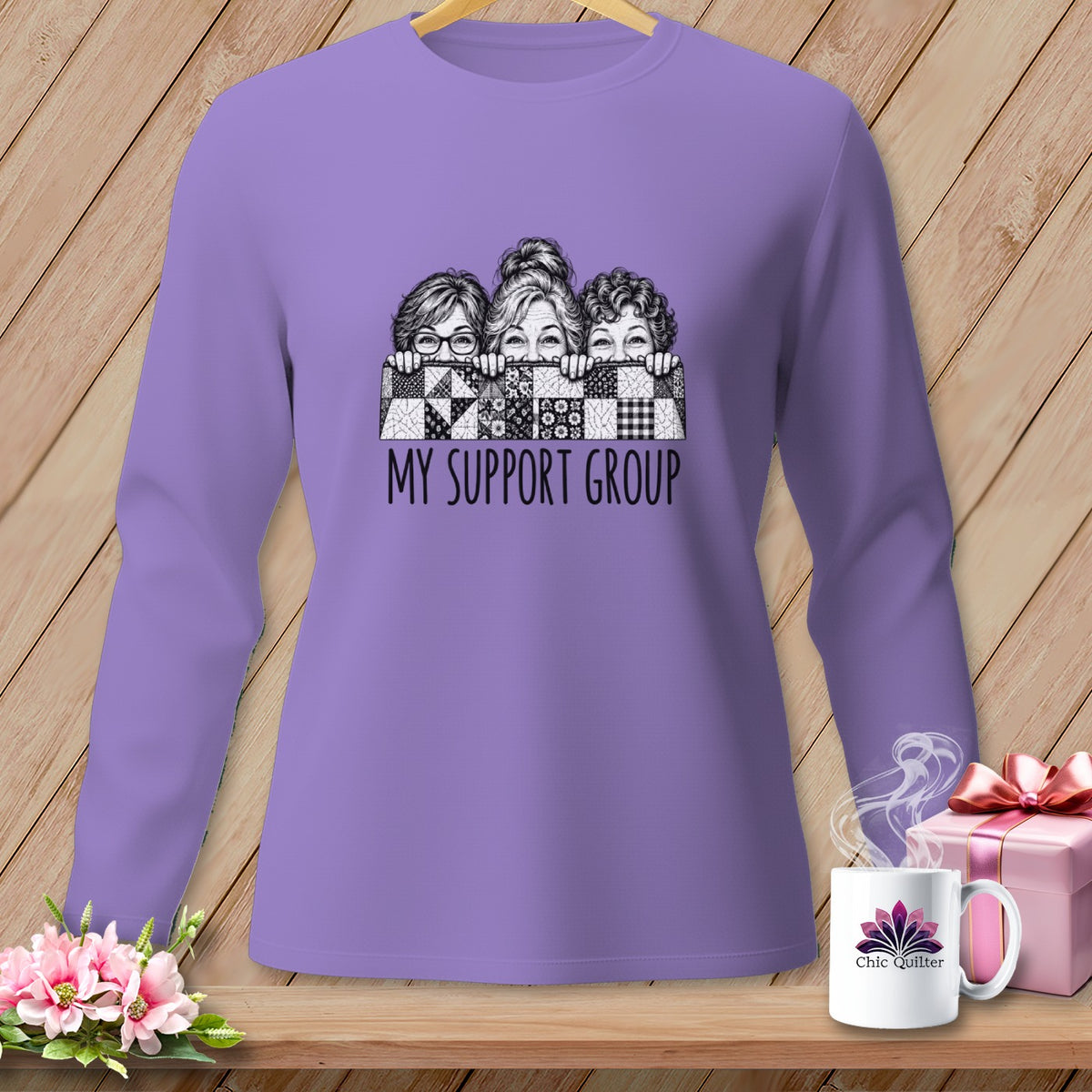 Purple long-sleeve shirt with three illustrated women peeking over a patchwork quilt and "MY SUPPORT GROUP" text.