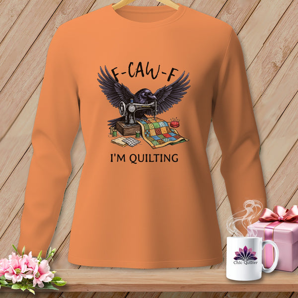 Raven at sewing machine with quilt, text "F-CAW-F I'M QUILTING".