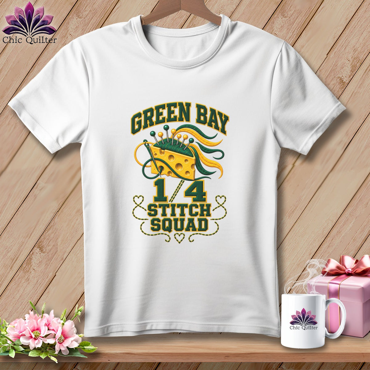 A white t-shirt features Green Bay Stitch Squad graphics with a Swiss cheese pincushion and sewing needles.