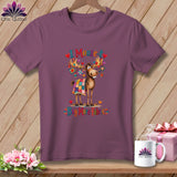 Purple t-shirt featuring a cartoon moose covered in a quilt, with text reading I Moose-t Buy More Fabric.