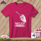 Pink t-shirt with a hand holding scissors cutting fabric, text reads 