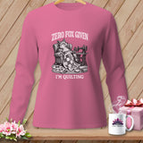 Pink long-sleeve shirt with a graphic of a fox in a chair, sewing machine, and quilt.