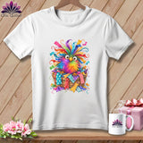 A white t-shirt featuring a colorful, whimsical bird sitting in a basket of fabric scraps.