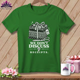Green t-shirt with stacked fabric, scissors, and text 