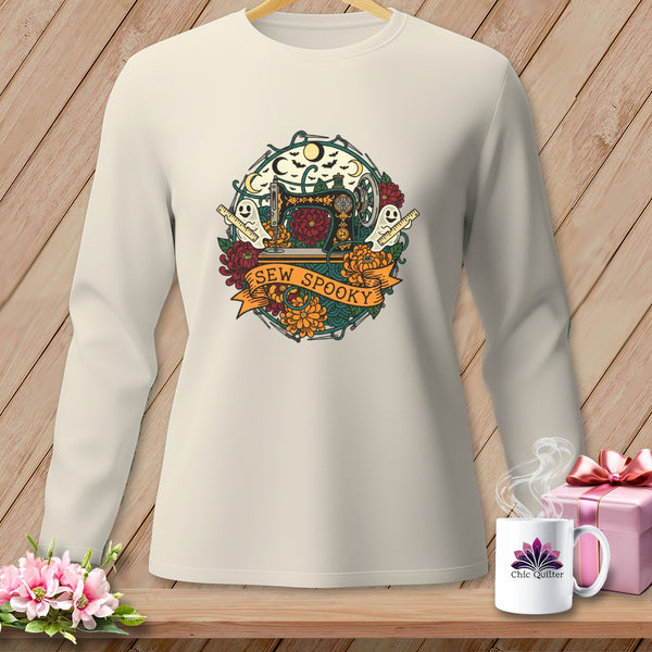 Long sleeve cream shirt with "Sew Spooky" graphic featuring sewing machine, ghosts, and flowers.