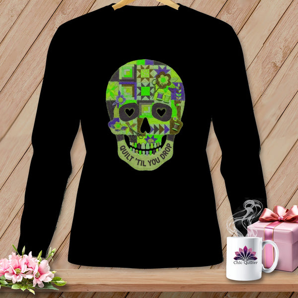 Black long-sleeve shirt with a green and purple patchwork skull graphic saying "Quilt 'Til You Drop".