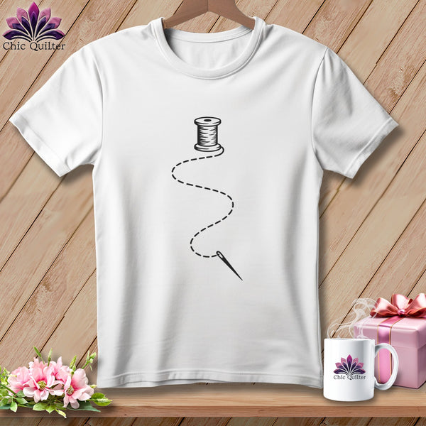 White t-shirt with a black spool of thread, needle, and dashed stitching design.