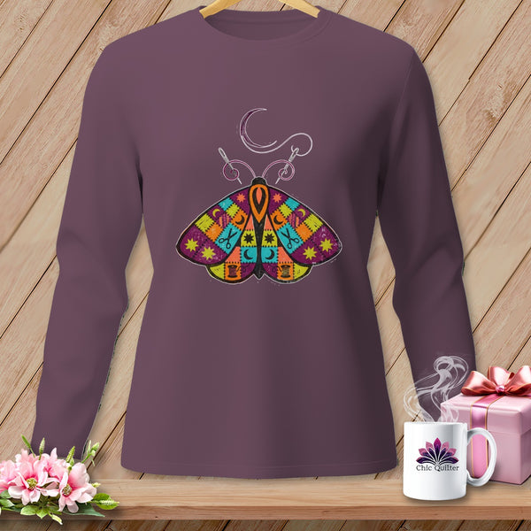 Long-sleeved purple shirt with a colorful quilt-patterned moth and sewing design.