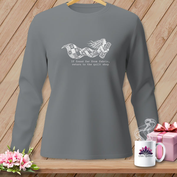 Grey long-sleeved shirt with a graphic of a woman and fabric, and text "return to the quilt shop".