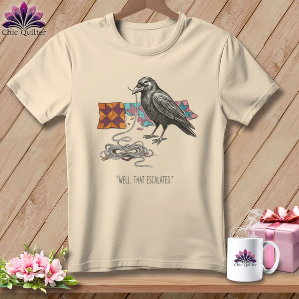 T-shirt graphic: crow pulling string from quilt, with text "Well, that escalated."