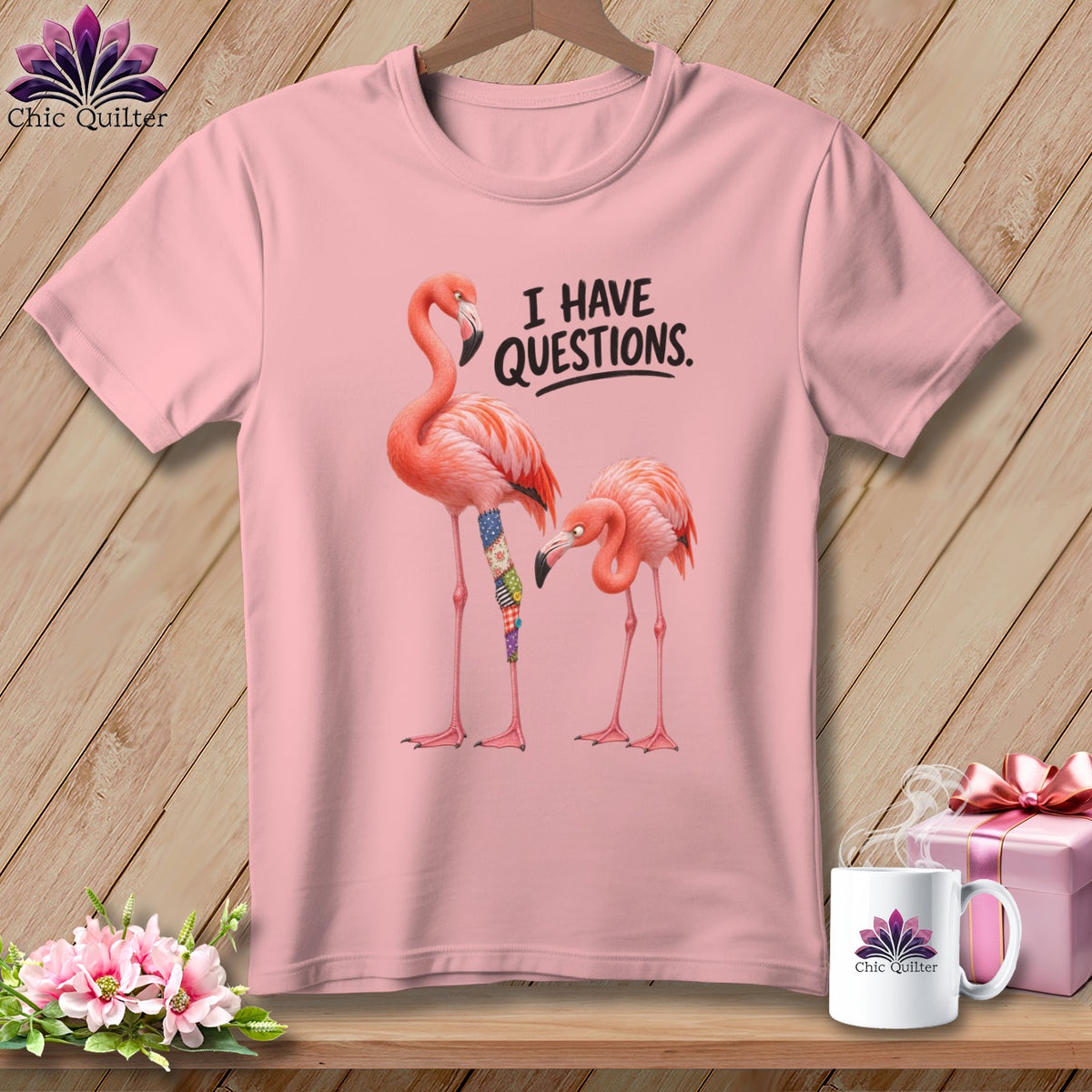 Pink t-shirt with two flamingos and text "I HAVE QUESTIONS."