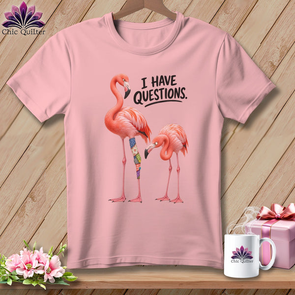 Pink t-shirt with two flamingos and text "I HAVE QUESTIONS."