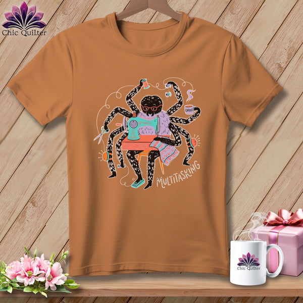 Brown t-shirt featuring a spider sewing with multiple arms, holding coffee, text "MULTITASKING".
