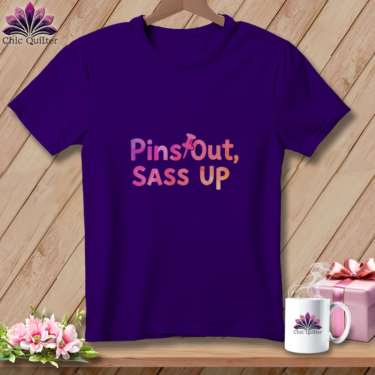 Purple t-shirt with "Pins Out, Sass Up" text and quilting logo.