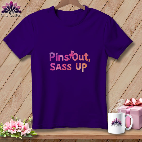 Purple t-shirt with "Pins Out, Sass Up" text and quilting logo.