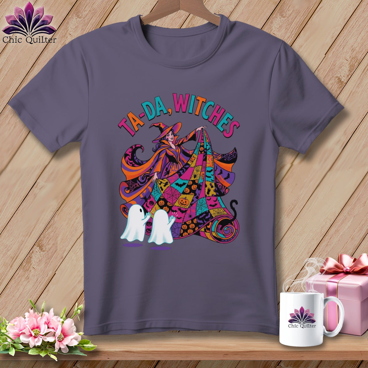 Purple t-shirt with Halloween graphic of a witch and ghosts, text "Ta-da, Witches."