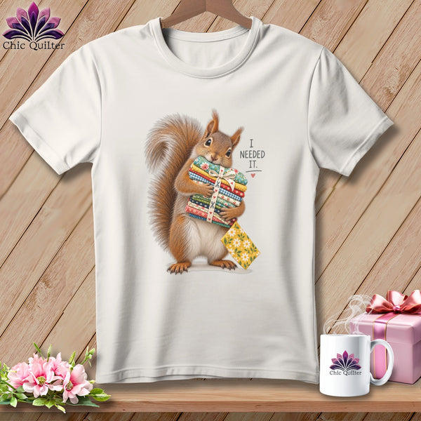 White t-shirt with squirrel holding fabric stacks and text "I needed it."